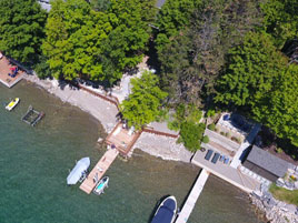 a residential shorefront with three boat docks